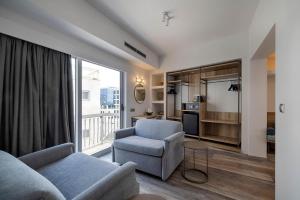 a living room with a couch and a chair at Xenophon Hotel in Athens