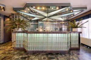 a lobby with a bar with plants on it at Xenophon Hotel in Athens