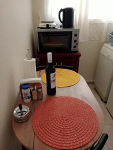 a bottle of wine sitting on top of a table at Stydio Damos in Kavála