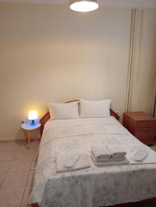 a bedroom with a large bed with towels on it at Stydio Damos in Kavála