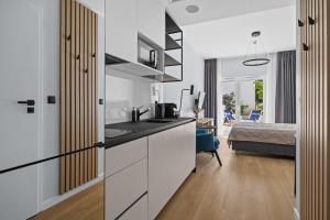a kitchen with a sink and a bed in a room at Aparthotel City Break Plac Wolności 6 by INA in Poznań