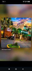 a picture of a hotel with a palm tree at Trevo Park Hotel in Nova Alvorada do Sul