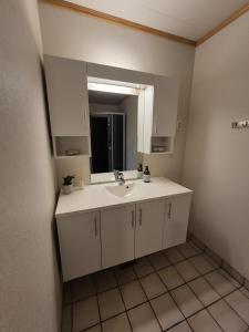 a bathroom with a sink and a mirror at Apartment on Leknes with a view in Vestvågøya