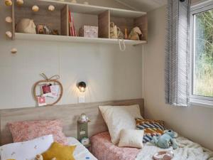 a small bedroom with a bed and a window at CAMPING PLEIN SOLEIL in Lourdes
