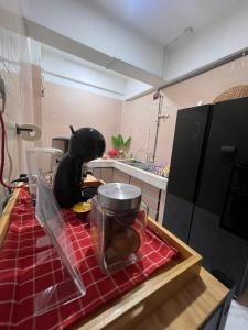a kitchen with a counter top with a table with a mixer at The Teduh Homestay By Rumah Mimpi in Kertih +4 photos