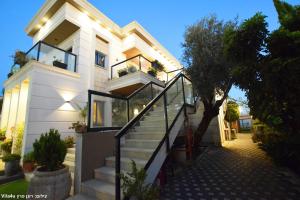 a white house with a staircase in front of it at סוויטה בכפר ירכא in Yarka