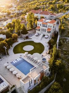 an aerial view of a mansion with a swimming pool at Alyasa Village in Jbeil