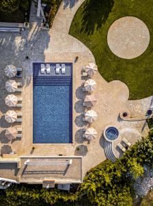 an overhead view of a swimming pool with umbrellas at Alyasa Village in Jbeil