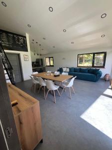 a living room with a table and chairs and a couch at Chalet 1602 in Avrig
