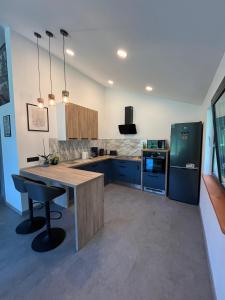 a kitchen with a wooden table and a refrigerator at Chalet 1602 in Avrig