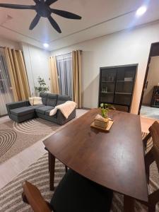 a living room with a table and a couch at The Teduh Homestay By Rumah Mimpi in Kertih