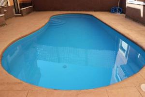 a large blue swimming pool in a building at Lagunas Ruidera 9 in Ruidera