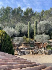 a garden with a stone staircase and trees and bushes at Mas Elaia in La Farlède