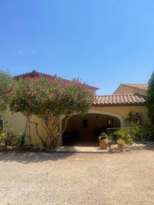 a house with a tree with red flowers on it at Mas Elaia in La Farlède