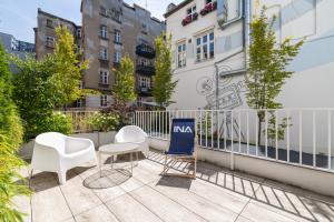 a balcony with chairs and a nintendo sign on it at Aparthotel City Break Plac Wolności 6 by INA in Poznań