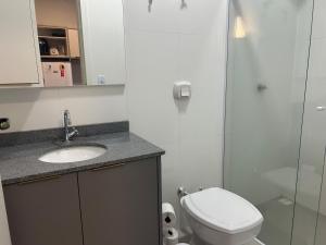 a bathroom with a toilet and a sink and a shower at J&C 04 Studio in Primavera do Leste