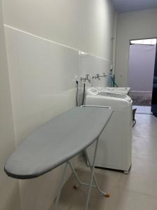 a bathroom with a sink and a washing machine at J&C 04 Studio in Primavera do Leste
