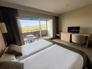 a hotel room with a large bed and a large window at Hotel Balneario de Gravalos in Grávalos +27 photos