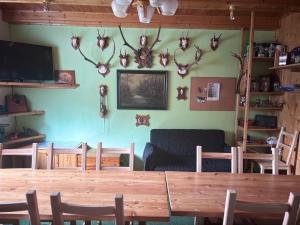 a dining room with a table and some antlers on the wall at Chalupa Pavlonka in Staré Hamry