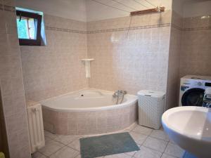 a bathroom with a tub and a sink at Chalupa Pavlonka in Staré Hamry +6 photos