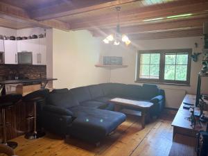 a living room with a couch and a table at Chalupa Pavlonka in Staré Hamry
