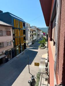 a motorcycle parked on a street next to a building at Apartment CenterZeroZone in Banja Luka +5 photos