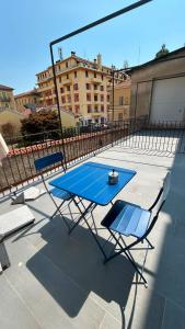 a table and two chairs and a blue table and chairs at Residenza SOGNO in Biella
