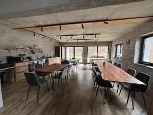 a large room with tables and chairs in a kitchen at Alpine Chalet Krkonose in Prosečné