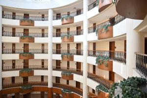 an apartment building with balconies and potted plants at Savoy Suites Greater Noida in Greater Noida