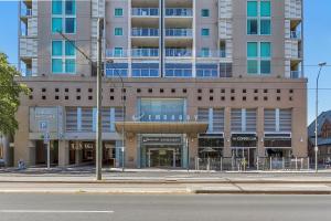 a large building on a city street with a building at Swainson at Embassy in Adelaide