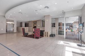 a lobby with chairs and a table in a building at Swainson at Embassy in Adelaide