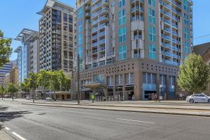 an empty street in front of a large building at Swainson at Embassy in Adelaide +3 photos