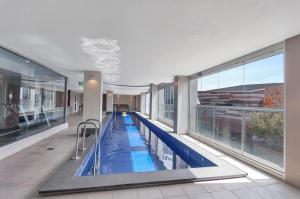 a large indoor swimming pool in a building at Swainson at Embassy in Adelaide