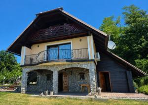 a house with a balcony on top of it at Vineyard Cottage - Ana in Metlika