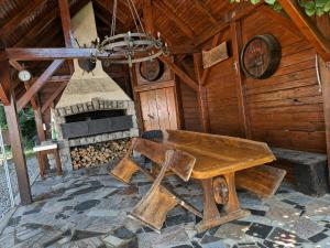 a wooden room with a wooden table and a stove at Vineyard Cottage - Ana in Metlika