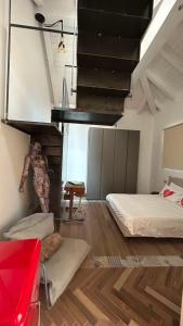 a room with two beds and a stair case at Residenza SOGNO in Biella