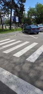 a crosswalk with a car parked in a parking lot at Studio Central Brancusi in Târgu Jiu