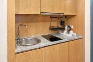 a kitchen counter with a sink and a mixer at Maistra Select Mlini Villas and Apartments in Mlini