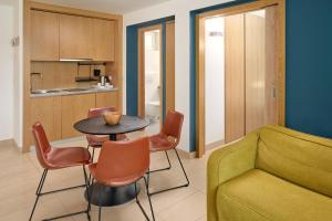 a living room with a table and chairs and a couch at Maistra Select Mlini Villas and Apartments in Mlini