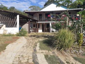 a house with a walkway in front of it at Villa Armor 2 in Nosy Be