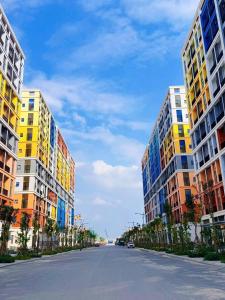 an empty street between two tall buildings on a city street at Sunora Stay A6 in Quang Ãm