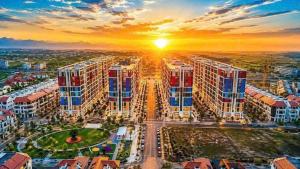 an aerial view of a large apartment complex at sunset at Sunora Stay A6 in Quang Ãm