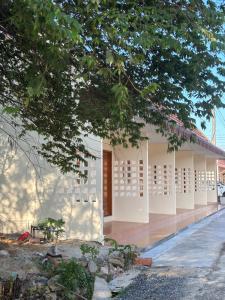 a white building with white shuttered windows on it at บ้านศรีสุธรรม3 Baansrisutham 3 in Don Sak