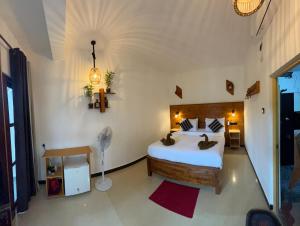 a bedroom with a large bed and a fan at Ella Forest Eco View in Ella