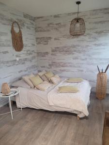 a bedroom with a bed and a wooden wall at Baune in La Bazoge