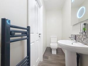 a white bathroom with a sink and a toilet at George and Dragon in Holmesfield