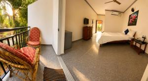 a bedroom with a bed and a balcony at Casa de Arambol in Arambol