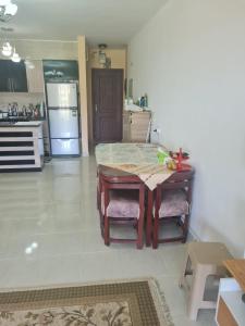 a kitchen with a table and chairs in a room at شاليه بلومار السخنة in Ain Sokhna