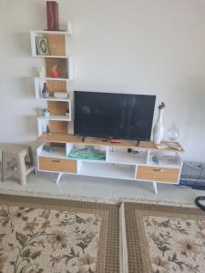 a entertainment center with a flat screen tv on it at شاليه بلومار السخنة in Ain Sokhna
