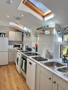 a kitchen with a sink and a dishwasher at Juliet Cottage, late Georgian treasure, charming, cosy and historic, only a short walk to Alnwick Castle in Alnwick